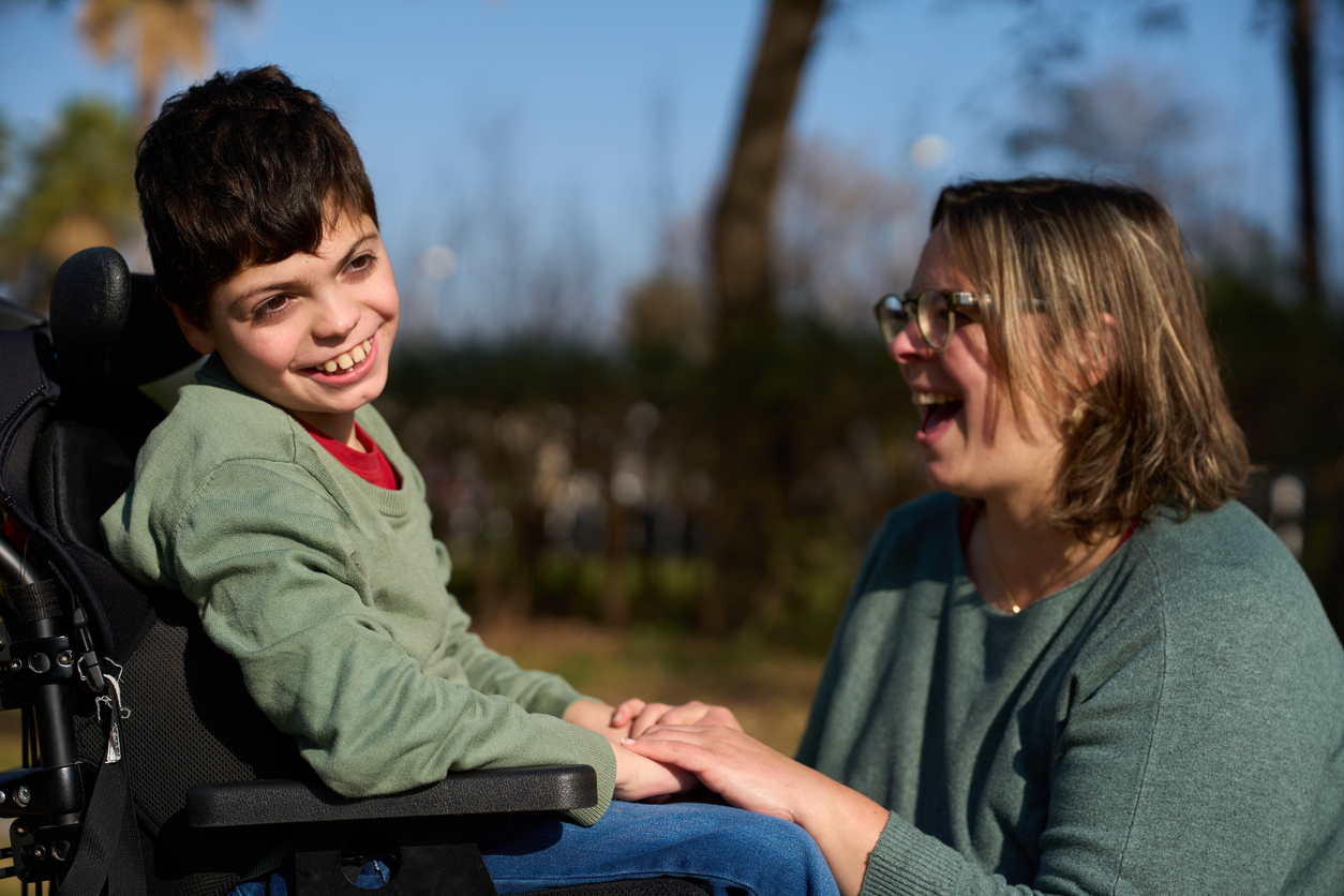 Happy disabled child smiling in the park
